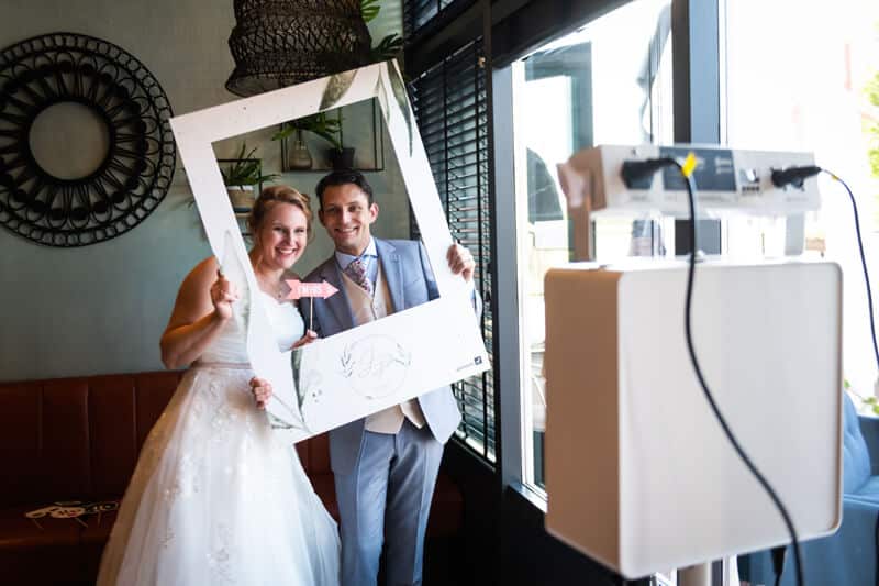 a man and woman holding a picture frame